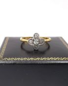 An Edwardian 18ct yellow gold and white metal old mine diamond floral ring, set with five round