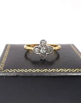 An Edwardian 18ct yellow gold and white metal old mine diamond floral ring, set with five round