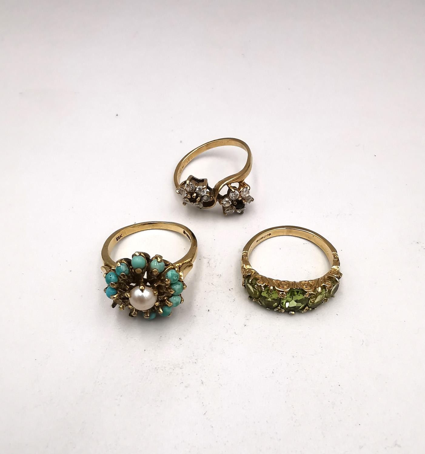 Three vintage 9ct yellow gold gem set rings, a Victorian style carved half hoop peridot set ring