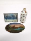 An oval reverse painted miniature on glass of people fishing with mother of pearl detailing to the