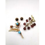 A yellow metal (tests as 9ct) garnet set berry sprig brooch along with a pink metal (tests as 9ct)