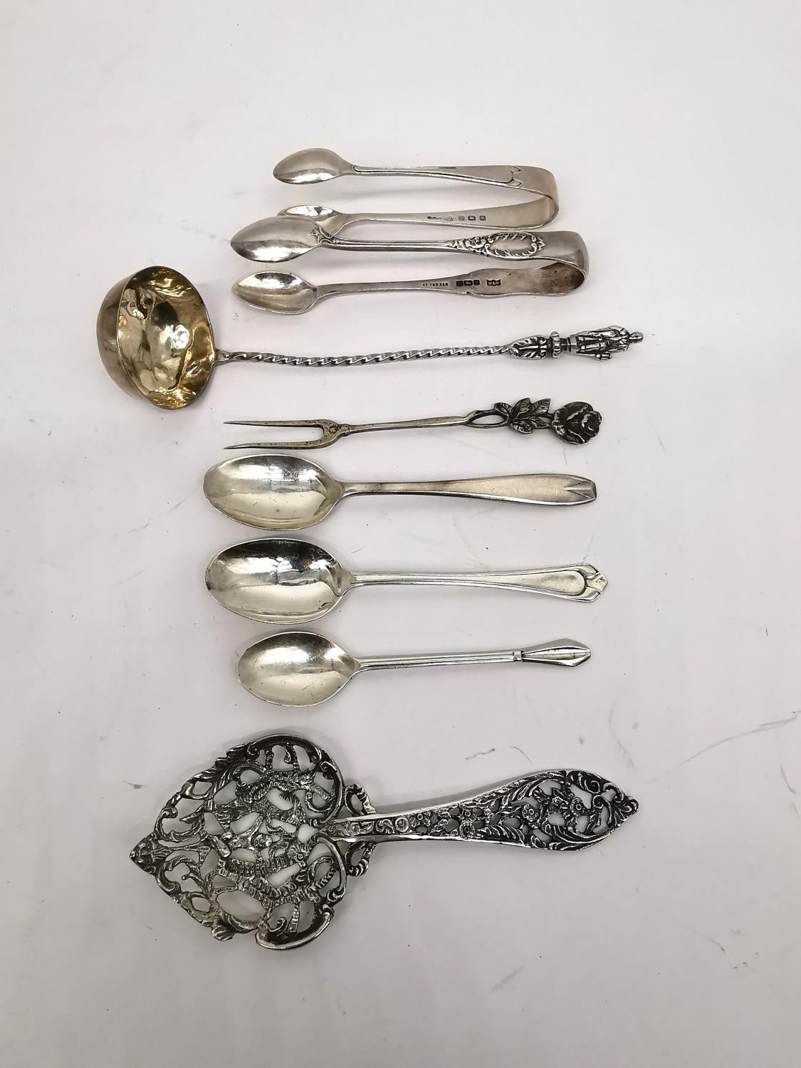 A collection of silver teaspoons, two pairs of sugar tongs, a pickle fork, a small sauce ladle and a - Image 2 of 16