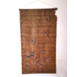 A Chinese 19th Chinese silk embroidered wall hanging decorated with a tree with birds and