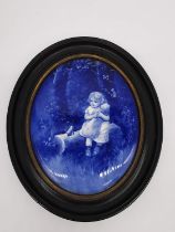 A framed 19th century Royal Doulton oval blue and white ceramic wall plaque decorated with girl with