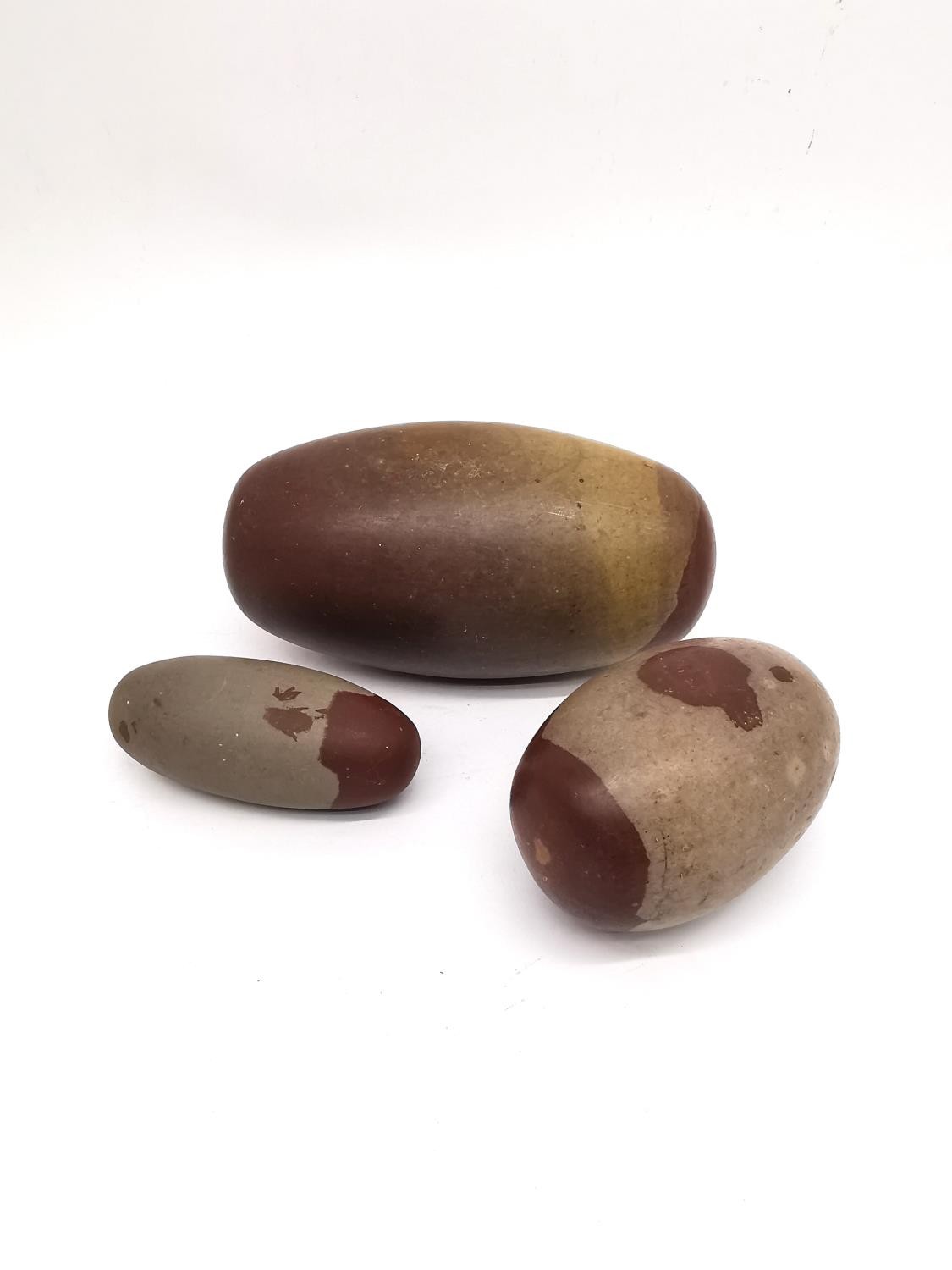 Three polished Indian Shiva Lingam stones of elongated egg form. Longest 18cm