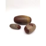 Three polished Indian Shiva Lingam stones of elongated egg form. Longest 18cm