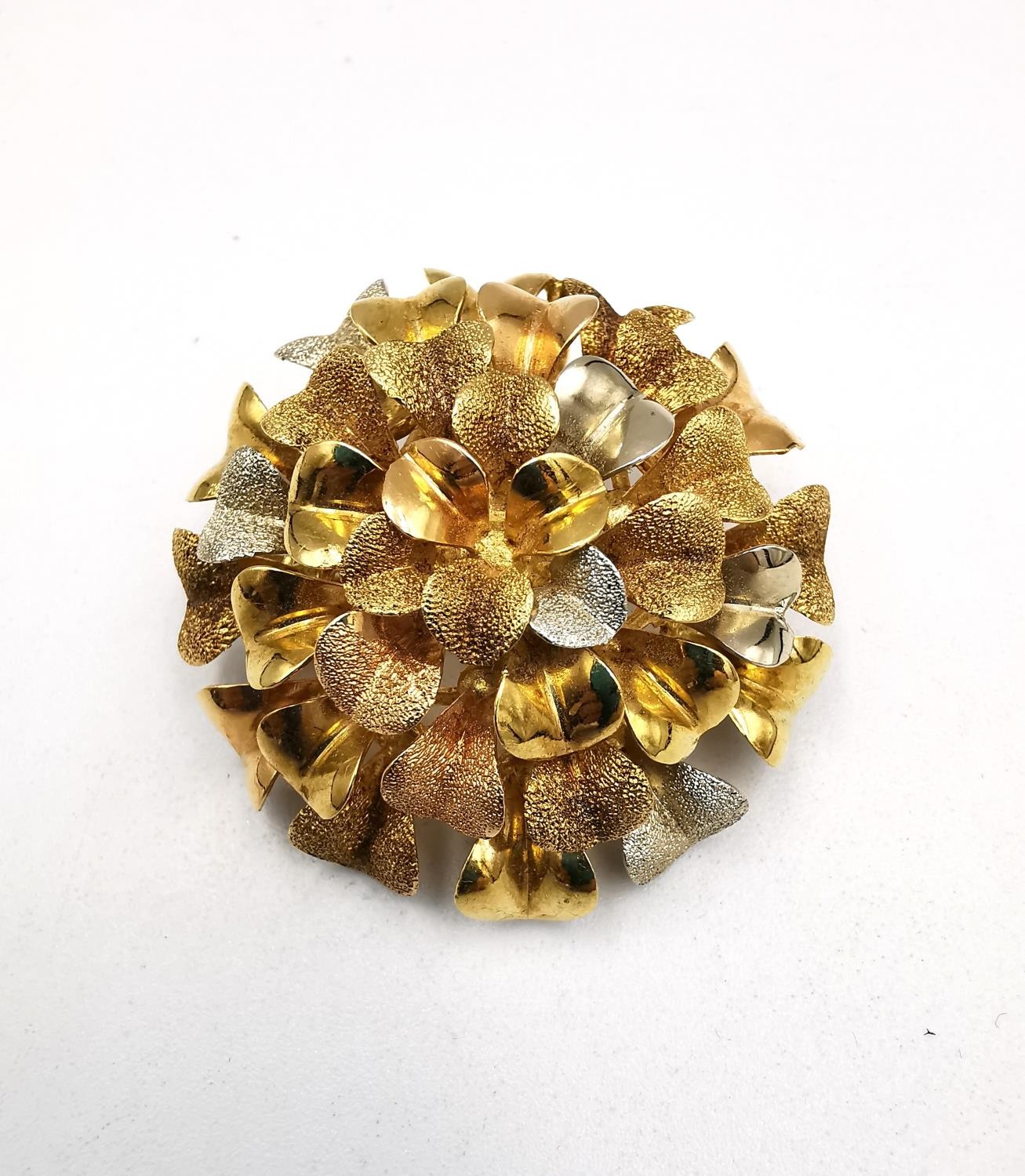 An Italian 18ct tri-colour gold stylised marigold brooch/pendant with texture to some of the petals.