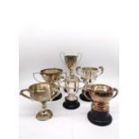 A collection of six silver golfing presentation trophies. Each inscribed with the competition and