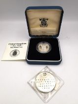 A silver swiss National Exhibition medal dated 1964 and a cased silver proof one pound coin with