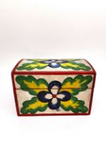 A Mexican folk art painted wooden casket with a carved frieze to the inside of lid depicting