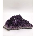 A large amethyst crystal geode cluster. L.27 x W.27cm H.8.5cm