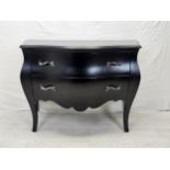 A contemporary ebonised bombe form commode chest. H.88 W.120 D.55cm.