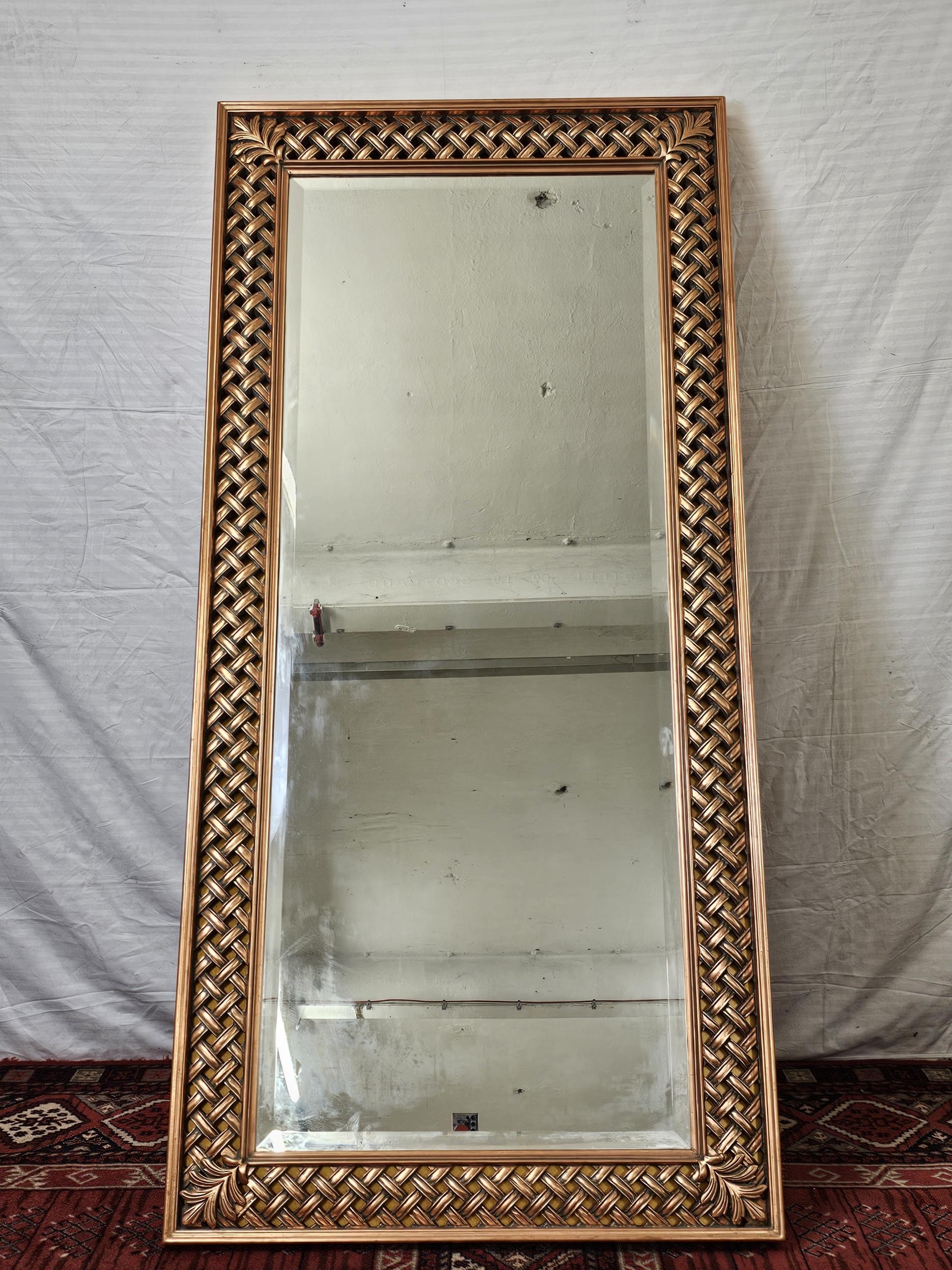 A contemporary carved and lacquered full height mirror. H.200 W.100cm.