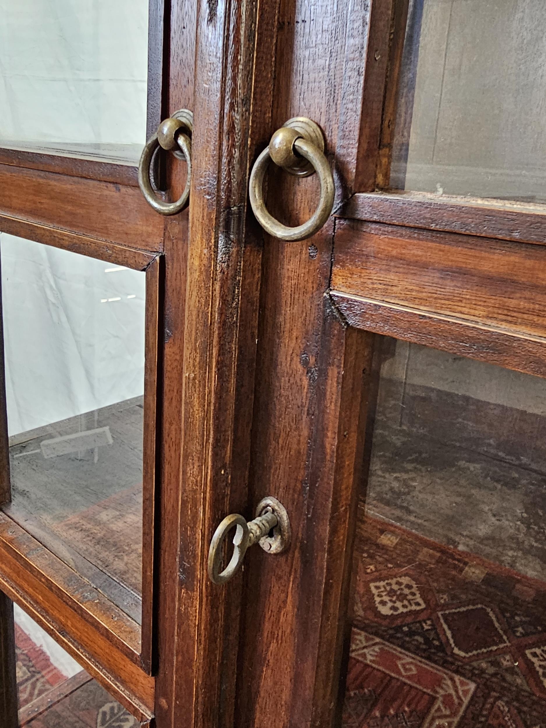 An Eastern teak bookcase cabinet fitted with drawers to the base. H.160 W.78 D.44cm. - Image 3 of 6