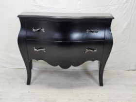 A contemporary ebonised bombe form commode chest. H.88 W.120 D.55cm.