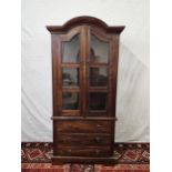 An Eastern teak bookcase cabinet fitted with drawers to the base. H.160 W.78 D.44cm.