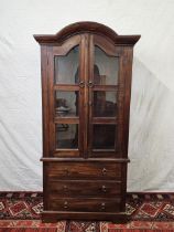 An Eastern teak bookcase cabinet fitted with drawers to the base. H.160 W.78 D.44cm.