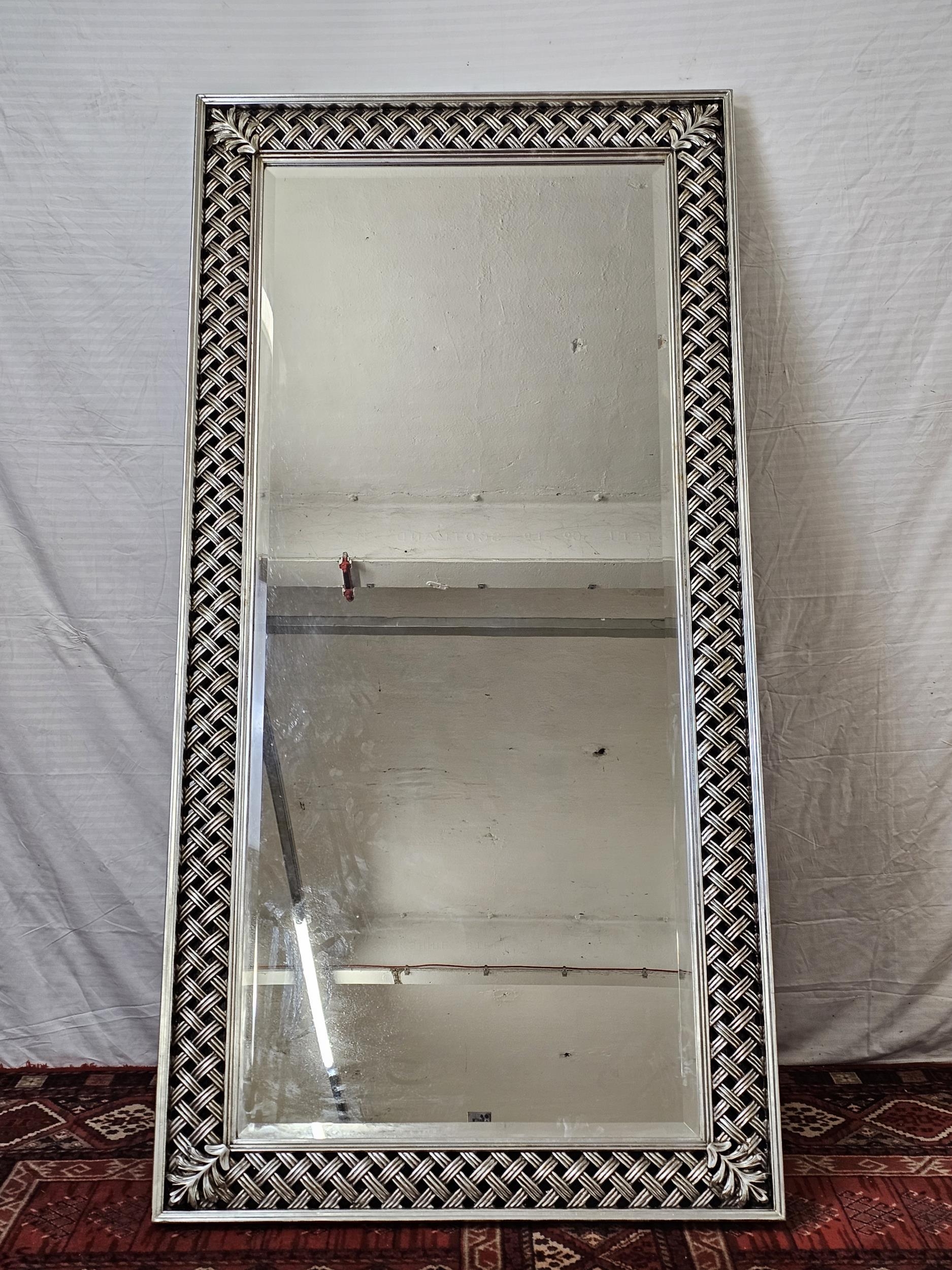 A contemporary carved and lacquered full height mirror. H.200 W.100cm.
