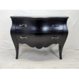 A contemporary ebonised bombe form commode chest. H.88 W.120 D.55cm.