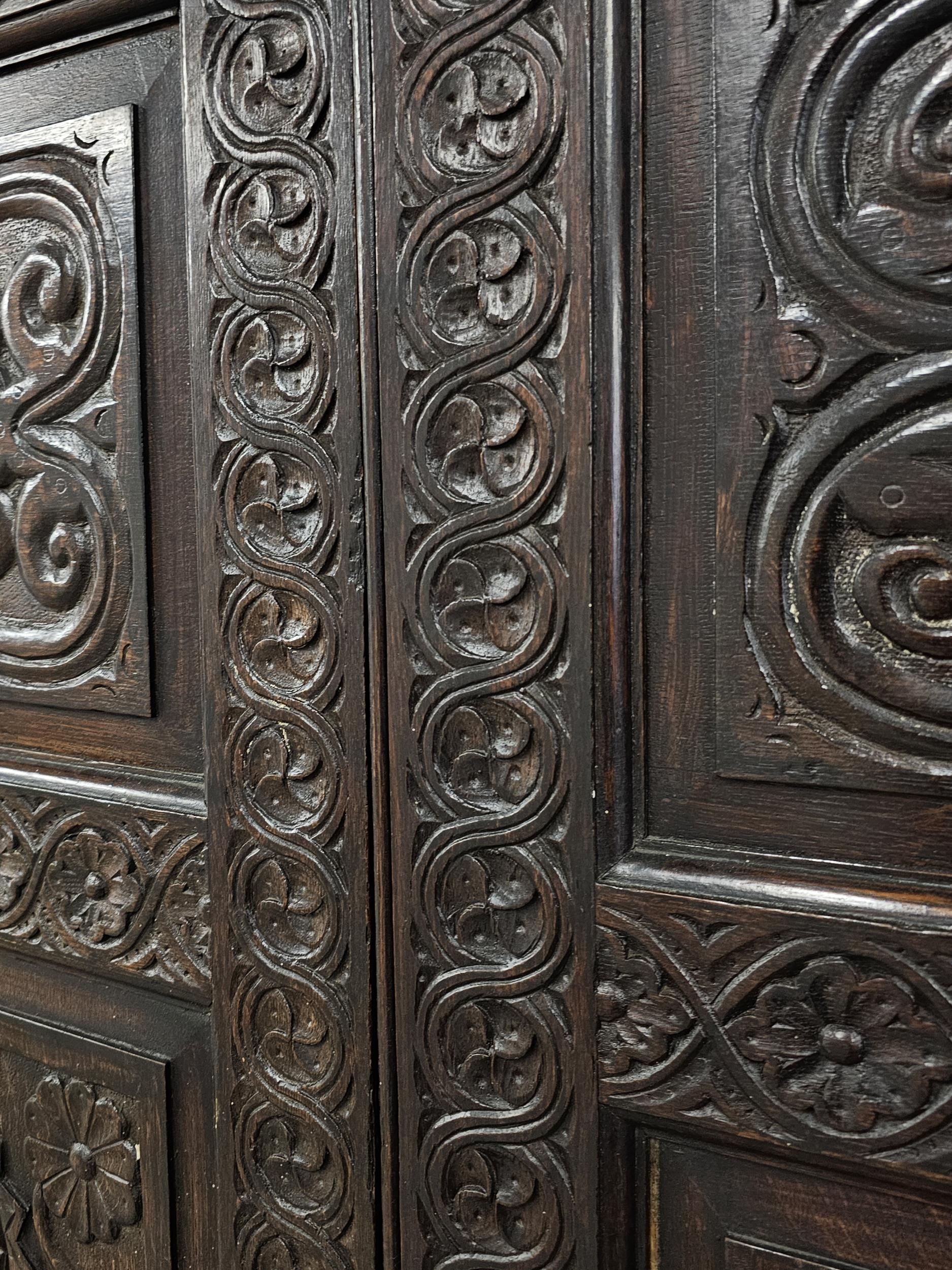 An 18th century carved oak hall cupboard fitted with base drawers on bracket feet. H.188 W.132 D. - Image 4 of 5