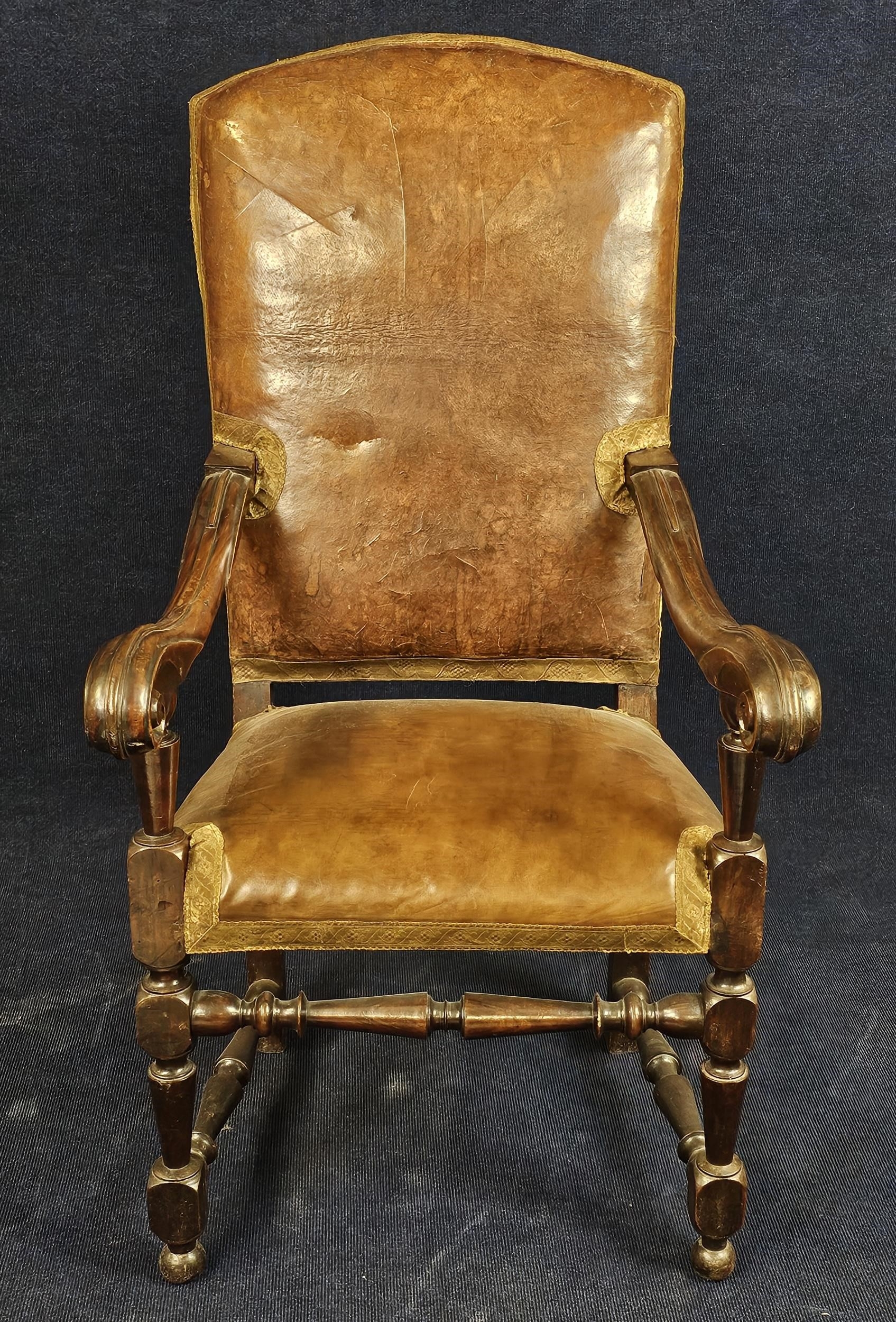 A 19th century Continental carved armchair in leather upholstery.