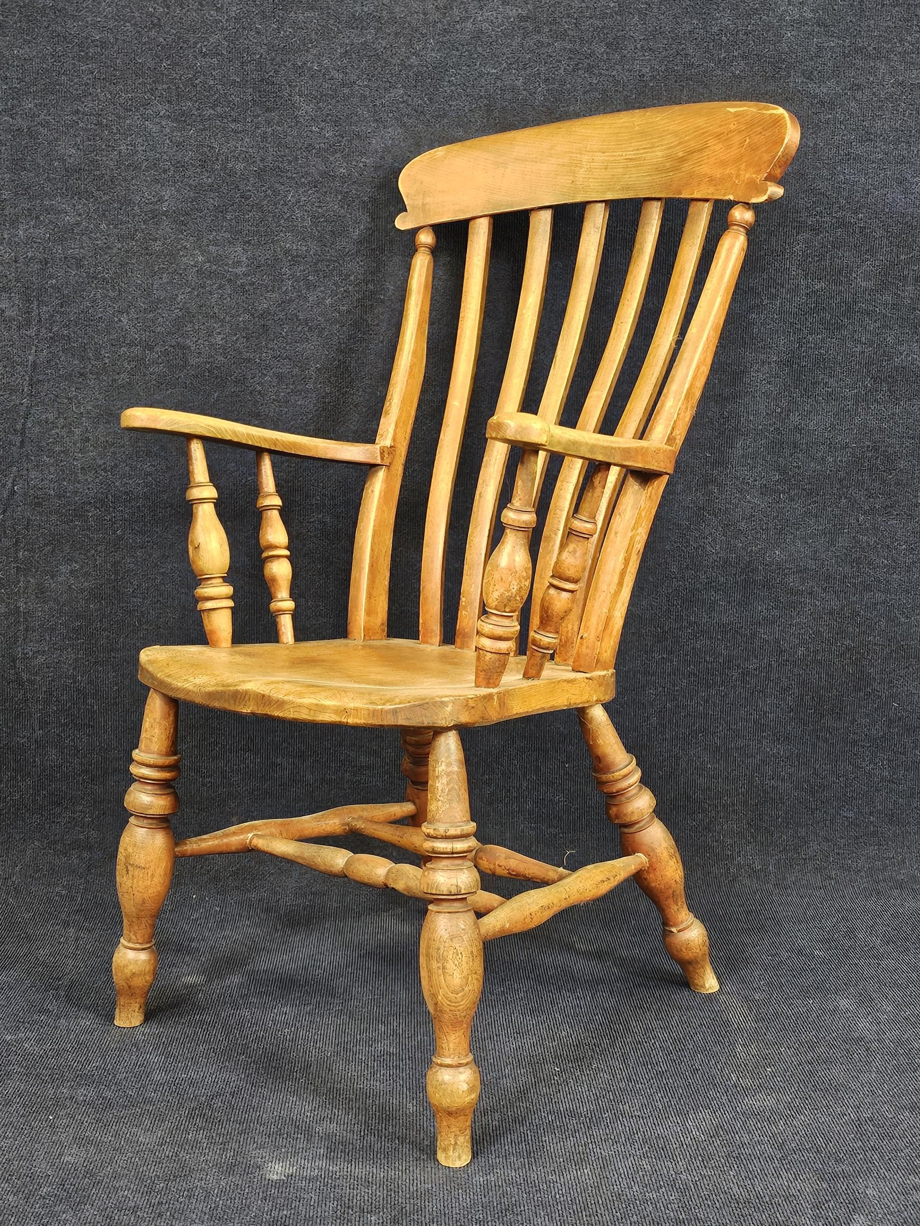 A 19th century elm seated stick back kitchen armchair. H.115 W.60 D.65cm. - Image 3 of 4