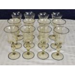 A set of twelve Venetian amber hand blown glass wine glasses with black rims. H.20cm.