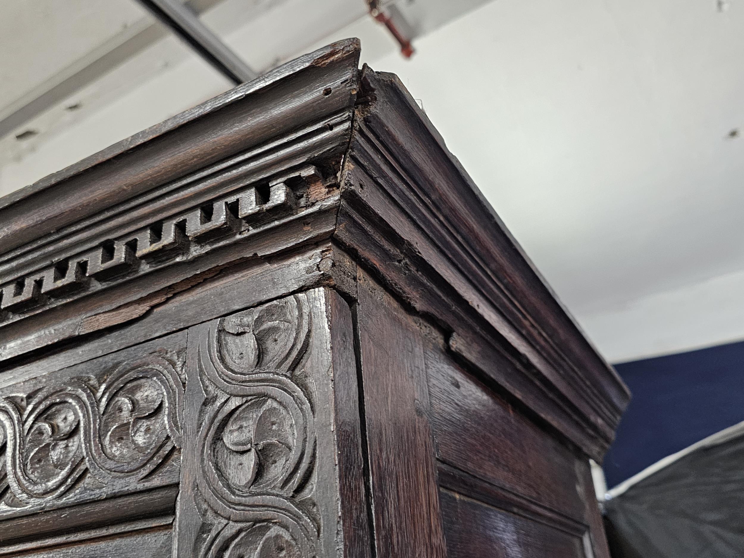 An 18th century carved oak hall cupboard fitted with base drawers on bracket feet. H.188 W.132 D. - Image 3 of 5
