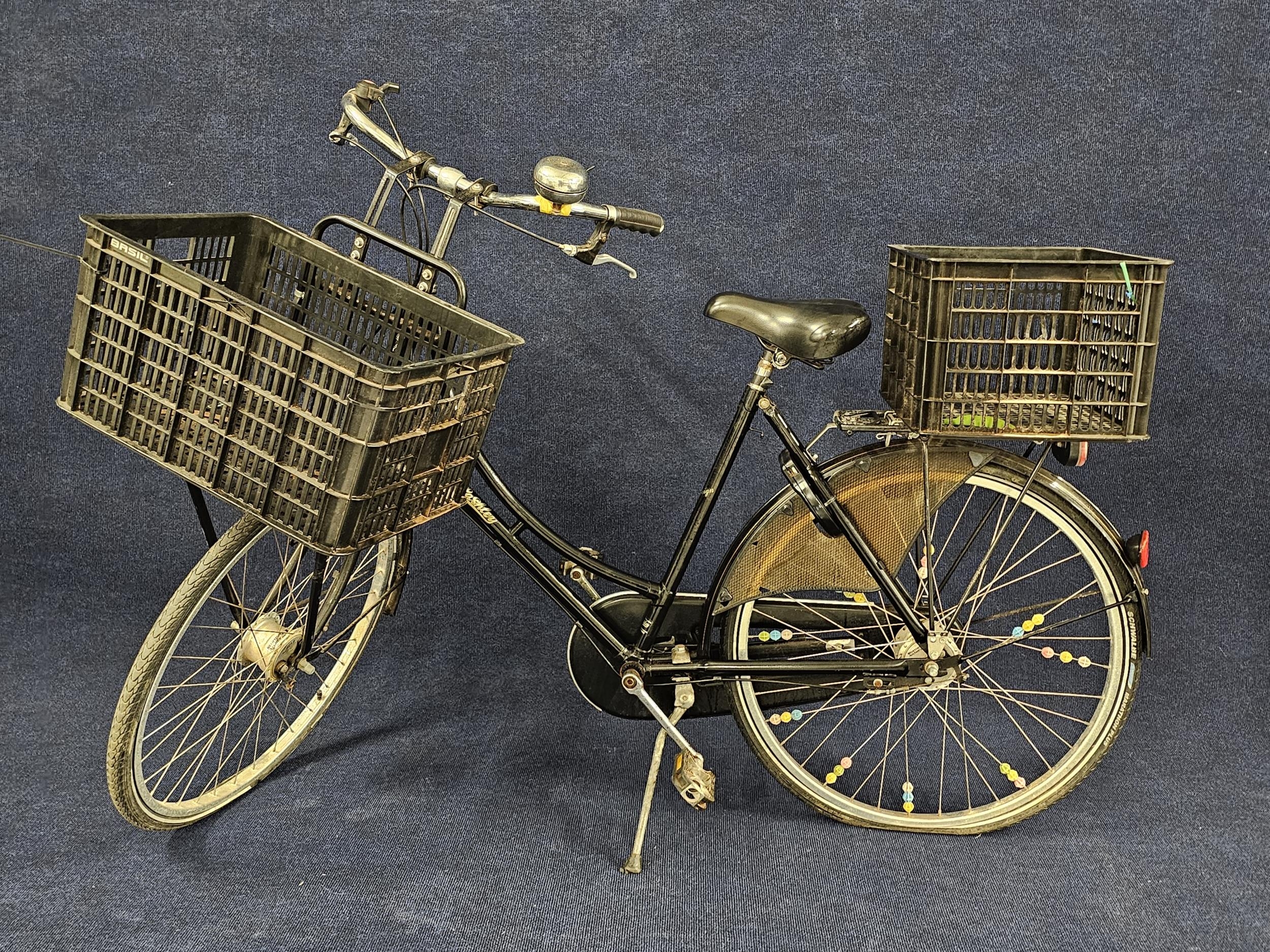 A Pashley ladies bicycle fitted with baskets to the front and back.