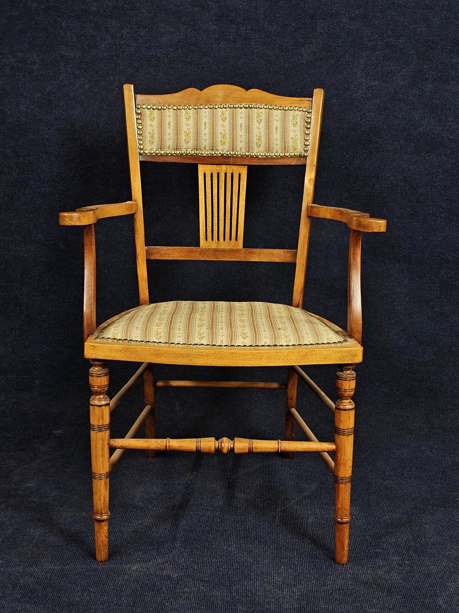 An Edwardian beech armchair.