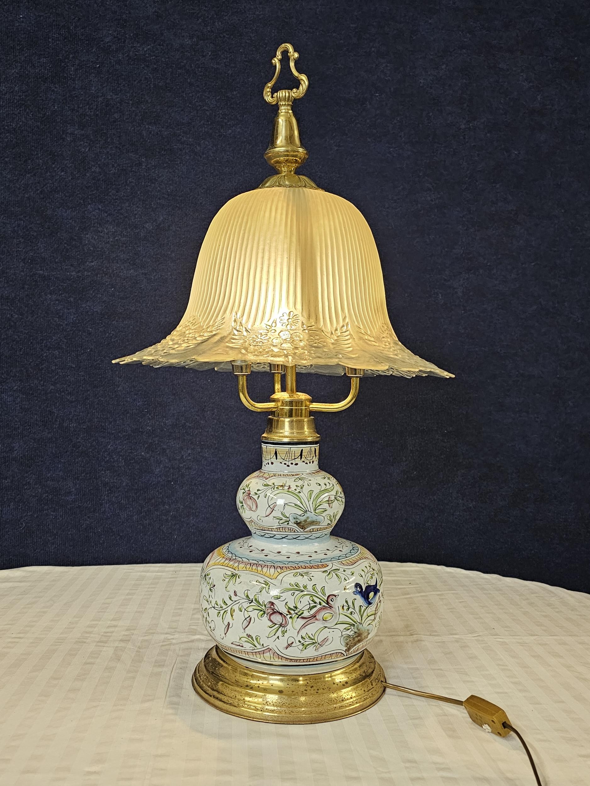 A large Ceramic Faience Quimper style lamp with glass shade. H.86cm.