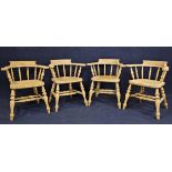 A set of four pitch pine smokers bow back armchairs.