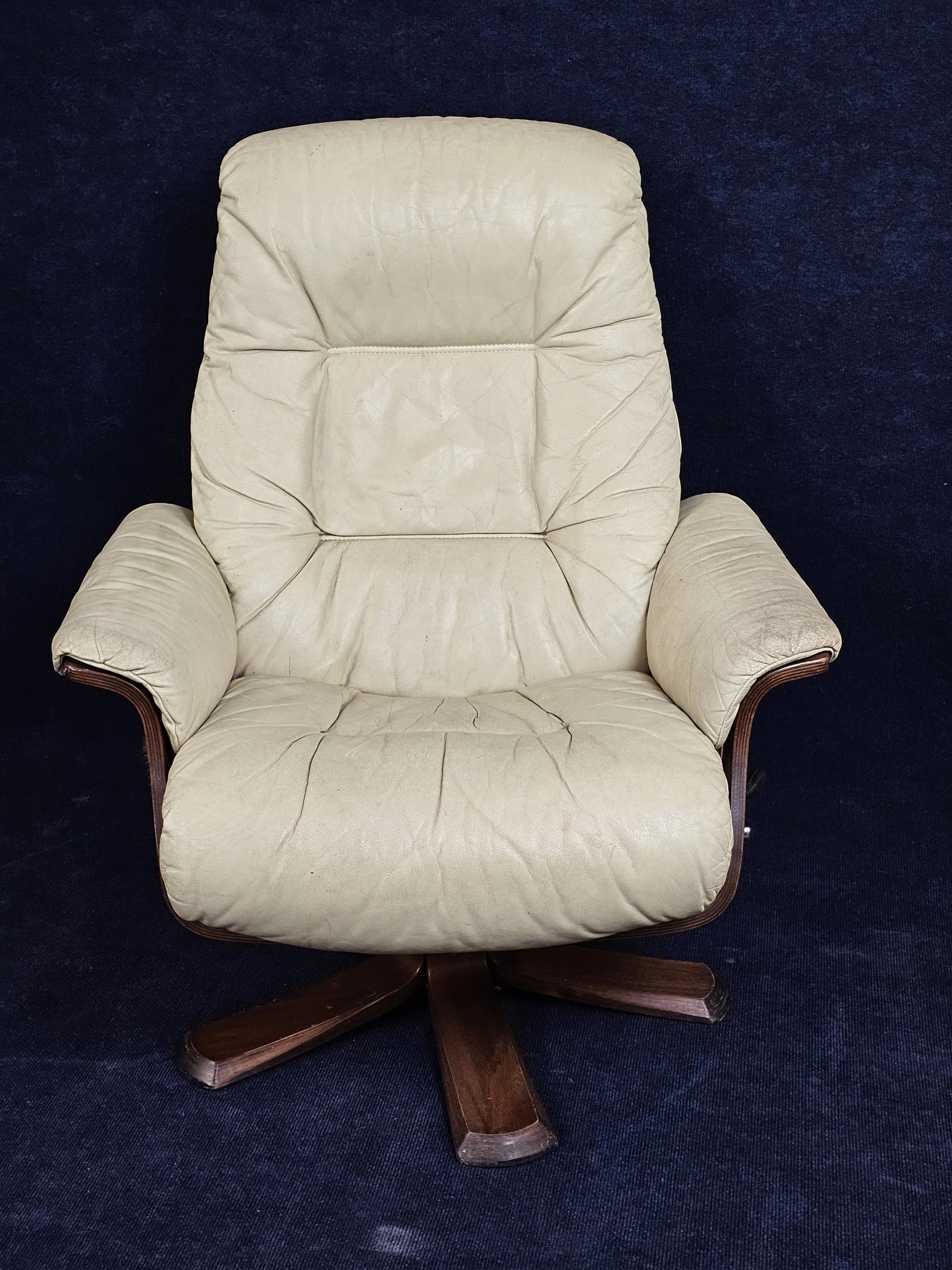 A contemporary Scandinavian leather upholstered armchair with reclining swivel action.