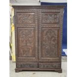 An 18th century carved oak hall cupboard fitted with base drawers on bracket feet. H.188 W.132 D.