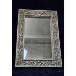 A contemporary carved hardwood framed mirror. H.110 W.77cm.