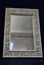 A contemporary carved hardwood framed mirror. H.110 W.77cm.