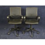 A pair of contemporary office desk armchairs.