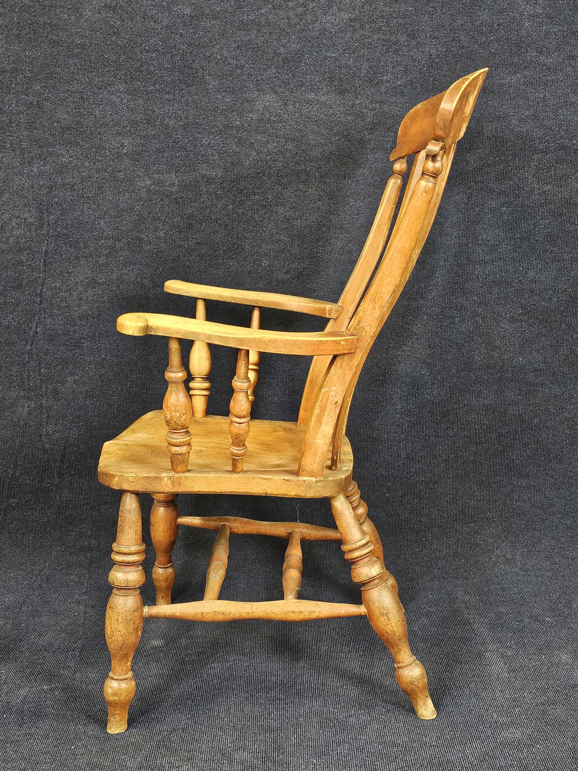 A 19th century elm seated stick back kitchen armchair. H.115 W.60 D.65cm. - Image 4 of 4