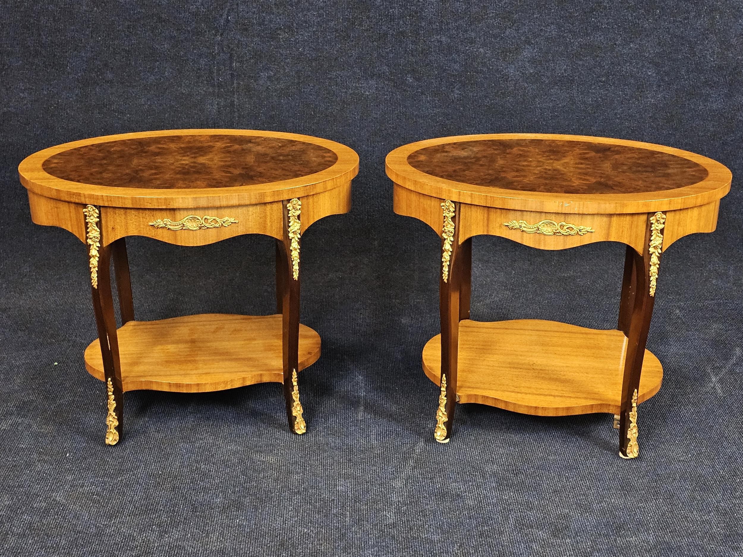 A pair of French style burr walnut lamp tables on cabriole supports with ormolu mounts. H.47 W.56