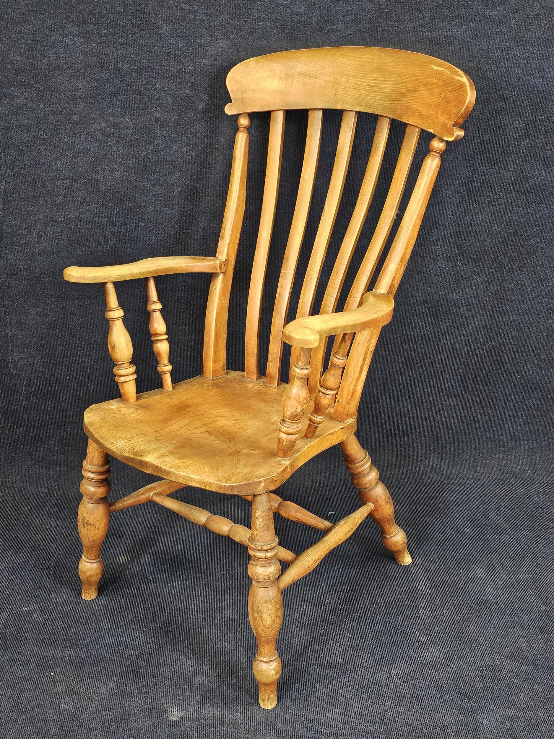 A 19th century elm seated stick back kitchen armchair. H.115 W.60 D.65cm. - Image 2 of 4