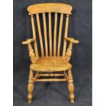 A 19th century elm seated stick back kitchen armchair. H.115 W.60 D.65cm.