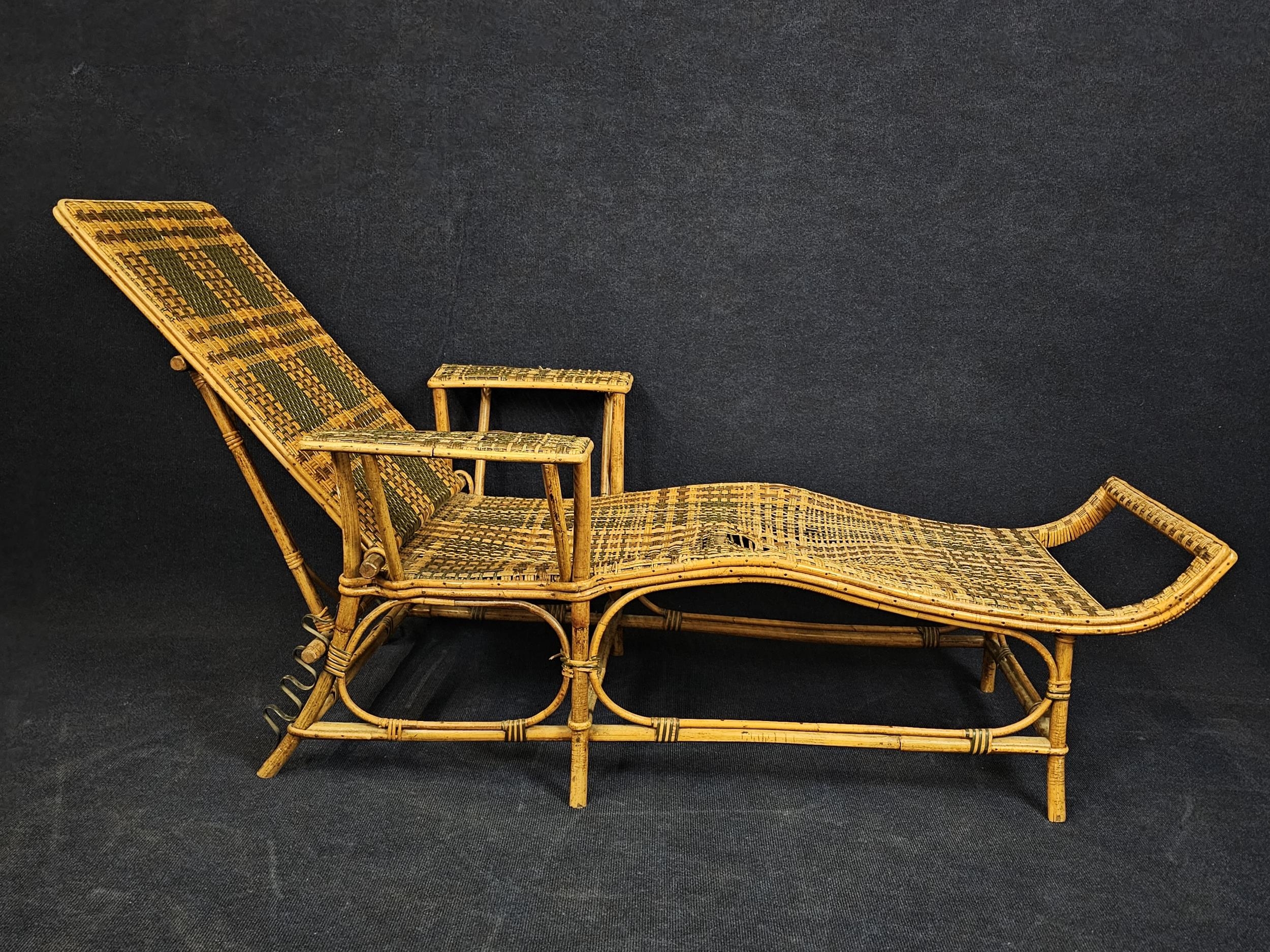 A mid century bamboo and wicker steamer lounger. H.90 W.180 L.78cm.