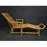 A mid century bamboo and wicker steamer lounger. H.90 W.180 L.78cm.