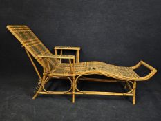 A mid century bamboo and wicker steamer lounger. H.90 W.180 L.78cm.
