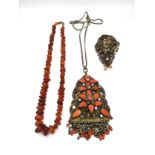 A vintage Baltic amber pebble bead necklace, a filigree and wirework coral bead brooch with a bird