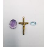 A 9 carat yellow gold cross, a loose blue paste stone and an oval mixed cut amethyst. Cross length