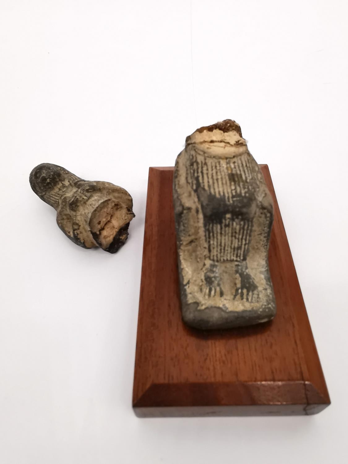 Two Egyptian-style clay ushabti on wooden plinth bases. One lying down and one seated on a - Image 4 of 9