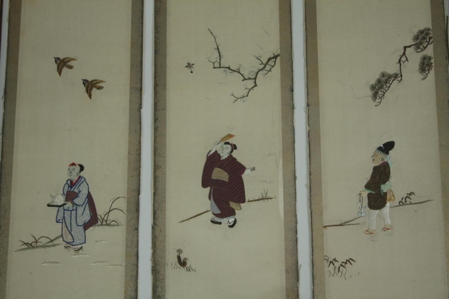 A set of eleven early 20th century Japanese silk embroidery panels depicting figures with gilded - Image 2 of 9