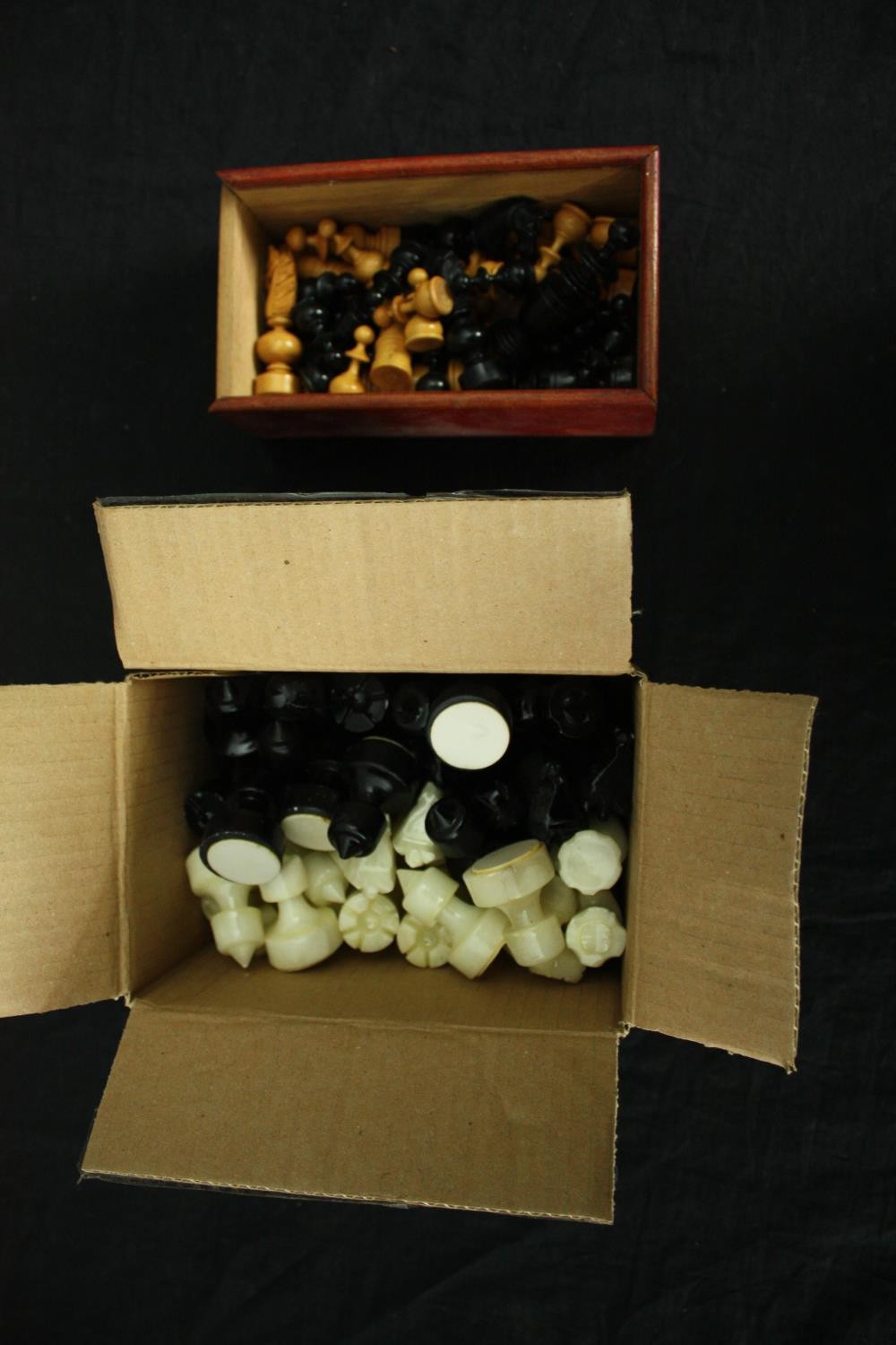 Two complete chess sets, carved wood and onyx. H.8cm. (largest).