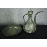 A 19th century Persian bronzed metal ewer with etched foliate and figural design along with a